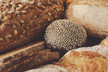 Bread background, closeup of white, black and rye loaves