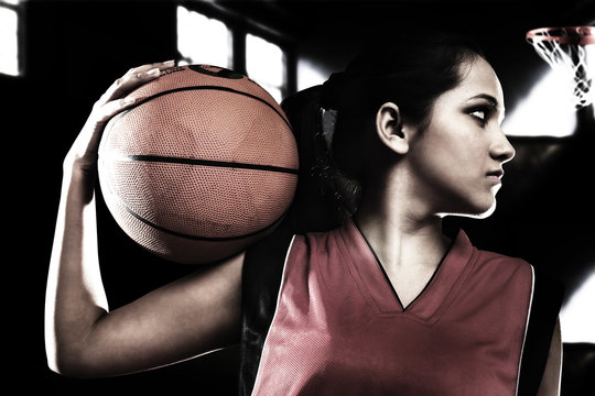 Girl posing with a basketball 