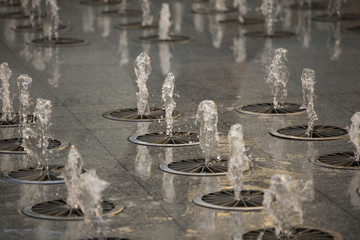 Water fountain. Water stream splashing on ground