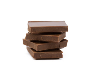 Milk chocolate pieces isolated on white background
