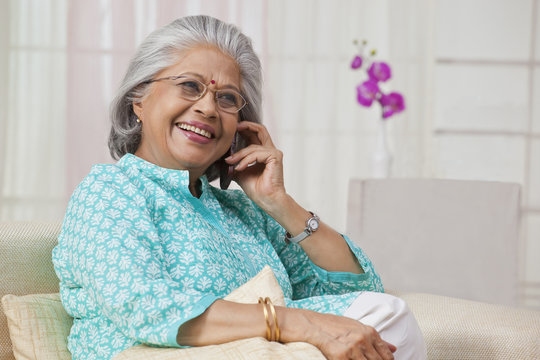 Portrait of an old woman talking on mobile phone
