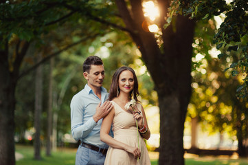 Young loving couple walking in the park