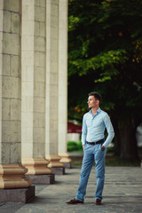 Nice man in casual clothes near the columns