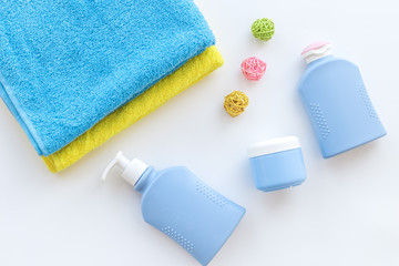 Bath accessories. Towels, soap, shampoo, lotion, cream on white background top view