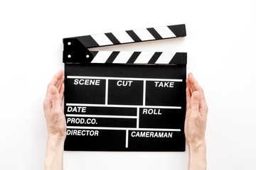 Fototapeta premium Filmmaker profession. Clapperboard on white background top view