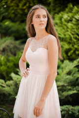 Fototapeta na wymiar Young beautiful woman in a light summer dress