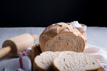 Freshly baked bread on wooden cutting board, Slice bread, wheat flour and cutting knife