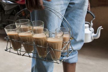 Midsection of Indian street seller selling tea 