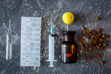 Pet cure concept. Pills and animal feed on grey stone background top view