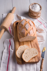 Freshly baked bread on wooden cutting board, Slice bread, wheat flour and cutting knife