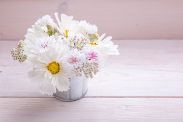 A bouquet of white flowers on white boards