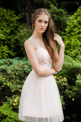 Young beautiful woman in a light summer dress