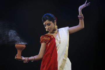 Bengali woman doing a Dhunuchi dance 