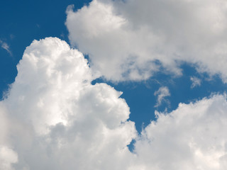 cumulus clouds in deep blue sky