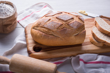 Freshly baked bread on wooden cutting board, Slice bread, wheat flour and cutting knife
