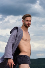 Morning concept. Sexy young macho on the sky.