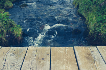 Wooden table on a river background