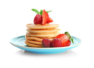 Plate with delicious pancakes on white background