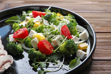 Plate with broccoli salad on table