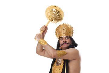 Man dressed as Raavan holding a mace 
