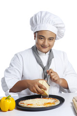 Portrait of chef grating cheese on pizza