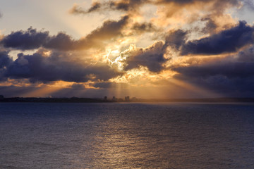 rays of sun through the clouds over the sea