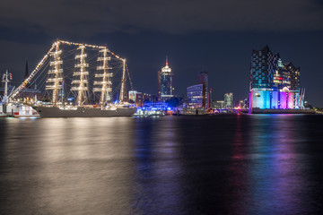Hamburg, Germany, Panorama of the Harbour at night. With the colored illuminated music hall at...