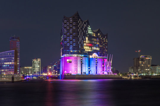Hamburg, Germany, Panorama of the Harbour at night. With the colored illuminated music hall at Christopher Street Day