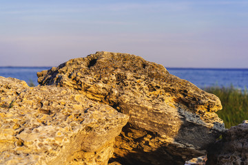 Fototapeta na wymiar Landscape beach with stones, grass, sea, blue sky