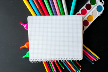 Back to school concept.School  stationery  on black background.