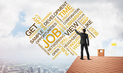 Young businessman standing on house roof and writing leadership skill concept. Mixed media