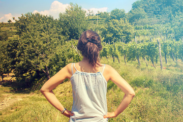 girl looking winery / fields cultivated for wine production