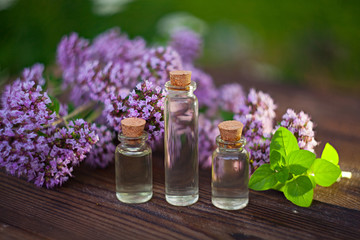 Obraz na płótnie Canvas Essence of lavender flowers on table in beautiful glass Bottle