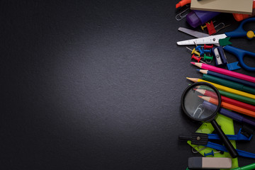 School supplies on the background of a black school board
