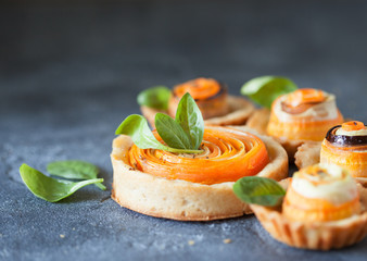 Homemade quiche tart with carrot, eggplant and cabbage roulade with soft cheese