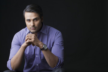 Portrait of handsome businessman over black background