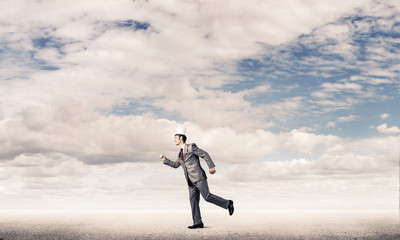 King businessman in elegant suit running and blue sky at backgro