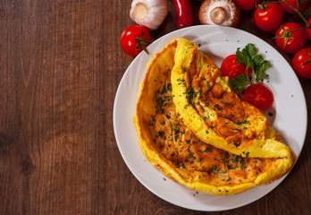 omelette in a plate on wooden table. with copy space. top view