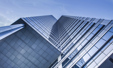 Fototapeta na wymiar Low angle view of modern skyscraper exterior and sky 