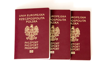 Polish biometric passports on white background.