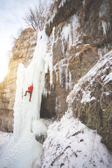 The climber climbs on ice.