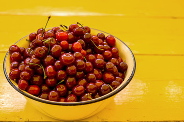 Ripe cherries on wooden table. View from above with copy space