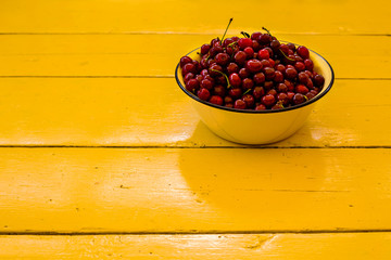 Ripe cherries on wooden table. View from above with copy space