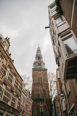 Fototapeta na wymiar Oudekerk Bell Tower with clock In Amsterdam, Netherlands