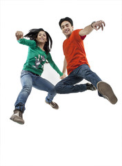 Boy and girl jumping in the air 