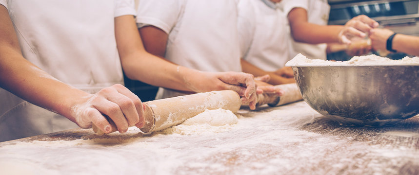 Young children make dough. Hands close up