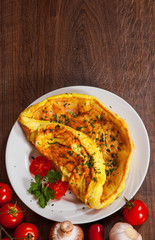 omelette in a plate on wooden table. with copy space. top view