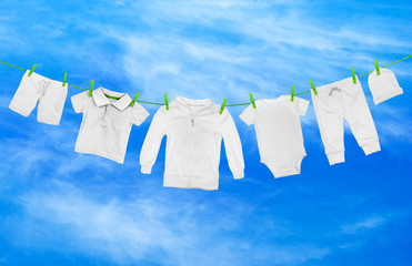Laundry line with light clothes, against the background of blue sky