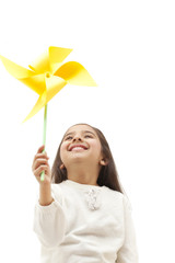 Obraz na płótnie Canvas Young girl holding a toy windmill 