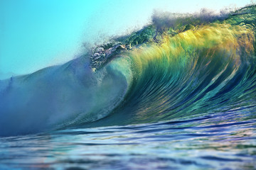 Barrel of bright colorful surfing ocean wave. Tropical background in sunset colors for sport activity with nobody on image.